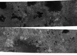 A photograph of Titan's northern latitudes. The dark features appear to be hydrocarbon lakes, but further images will be needed to see if the dark spots remain the same (as they would if they were lakes)