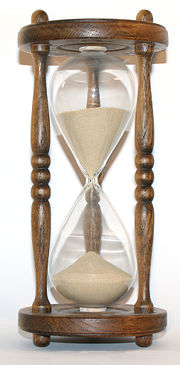 The flow of sand in an hourglass can be used to keep track of elapsed time. It also concretely represents the present as being between the past and the future.