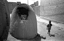A typical street scene at Timbuktu, Mali, with omnipresent bread-baking ovens