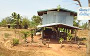 Isan houses are often built on stilts: the area underneath the house can be used as a living area, for storage or for keeping animals. The large jar or ohng (โอ่ง) to the left of this house is used for storing water.