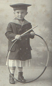 A boy with a hoop. Hoops have long been a popular toy across a variety of cultures.