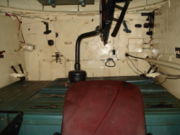 Interior of a T-34-85 tank viewed from the driver's hatch, showing the ammunition boxes on which the loader had to stand in the absence of a turret basket. In the foreground is the driver's seat.