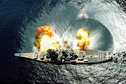 USS Iowa fires a full broadside of nine 16 inch (406 mm) / 50-caliber and six 5 inch (127 mm) / 38-caliber guns during a target exercise. Note concussion effects on the water surface, and 16 inch (406 mm) gun barrels in varying degrees of elevation.