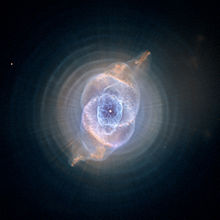 Image of NGC 6543 processed to reveal the concentric rings surrounding the inner core. Also visible are the linear structures, possibly caused by precessing jets from a binary central star system.