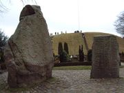 The Jelling Stones, commonly referred to as Denmark's "birth certificate", seen from the north with "Gorm's Mound" in the background.