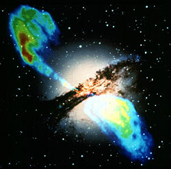 A radio map of the galaxy Centaurus A (upper left and lower right) is overlaid across the optical image (center), showing two lobes from the jets being generated by an active nucleus. Credit:NASA.