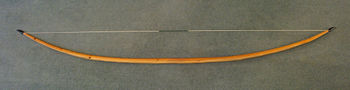 Self-yew English longbow, 6 ft 6 in long, 105 lbf draw force.