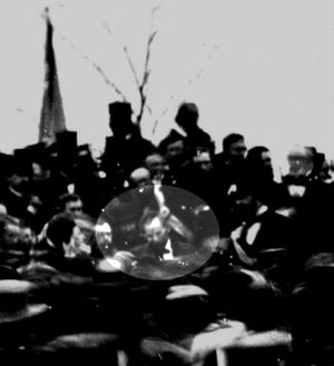 The only confirmed photo of Abraham Lincoln at Gettysburg (seated), taken about noon, just after Lincoln arrived and some three hours before he spoke. To Lincoln's right is his bodyguard, Ward Hill Lamon.