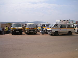 A row of minibus share taxis waiting to depart in Kigali, Rwanda