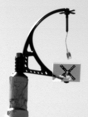 Phoenix deployed and then imaged the MET weather mast that holds the wind-strength and direction-measuring telltale at a height of 2.3 m. This enhanced image shows wind from the northeast on Sol 3.