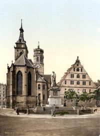 The Protestant Stiftskirche (originally built in 1170) pictured around 1900. In the foreground: the memorial on Schiller square.