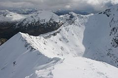 The CMD Arête under deep snow in spring, from the summit of Carn Mòr Dearg.